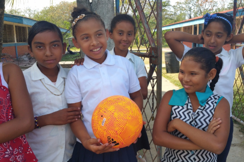 Girls in Colon are excited to receive a new soccer ball donated by Adidas