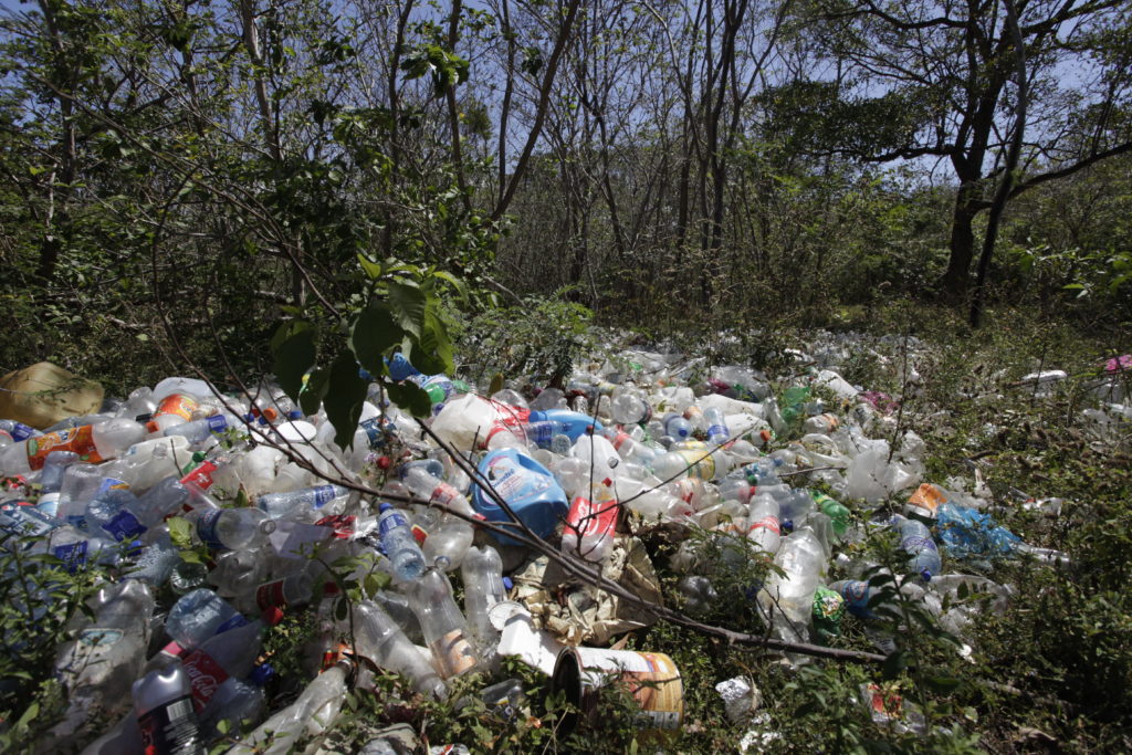 A large mount of plastic waste in the middle of a forest clearing in Nicaragua.